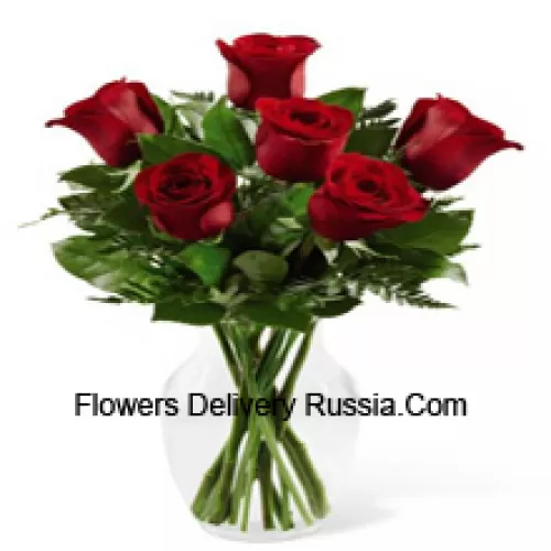 7 Red Roses With Some Ferns In A Glass Vase