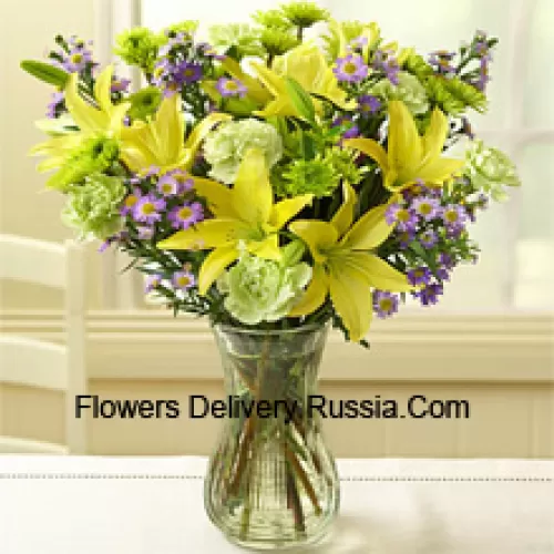 Yellow Lilies And Other Assorted Flowers Arranged Beautifully In A Glass Vase