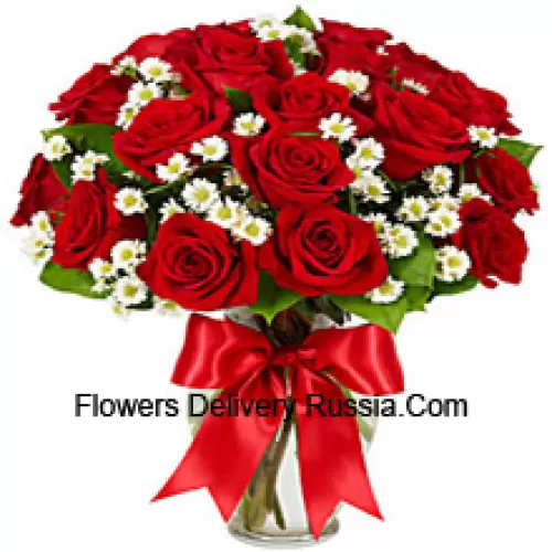 25 Red Roses With Some Ferns In A Glass Vase