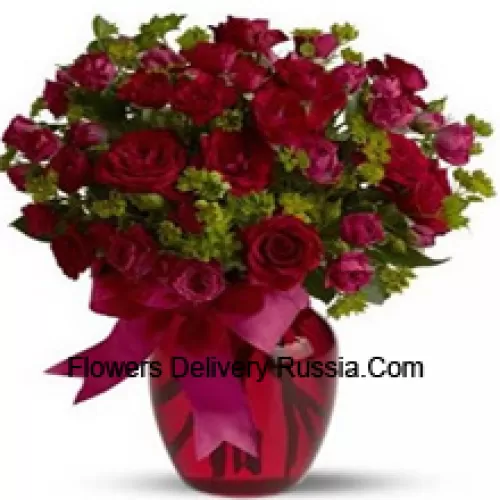 26 Red And 25 Pink Roses With Some Ferns In A Glass Vase