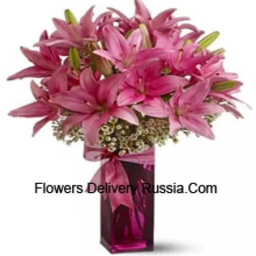 Beautiful Pink Lilies With Some Ferns In A Glass Vase