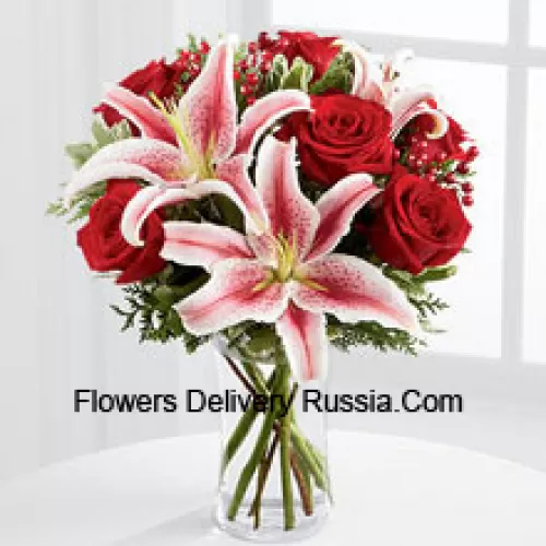This Bouquet is a simply stunning display of seasonal glamour they won't be able to resist. Rich red roses are paired with the dazzling beauty of Stargazer lilies accented with holiday greens, berry sprays and a bordeaux satin rbbon for an elegant look. Arranged in a clear glass vase, this bouquet will add to the magic and wonder of their holiday festivities. (Please Note That We Reserve The Right To Substitute Any Product With A Suitable Product Of Equal Value In Case Of Non-Availability Of A Certain Product)